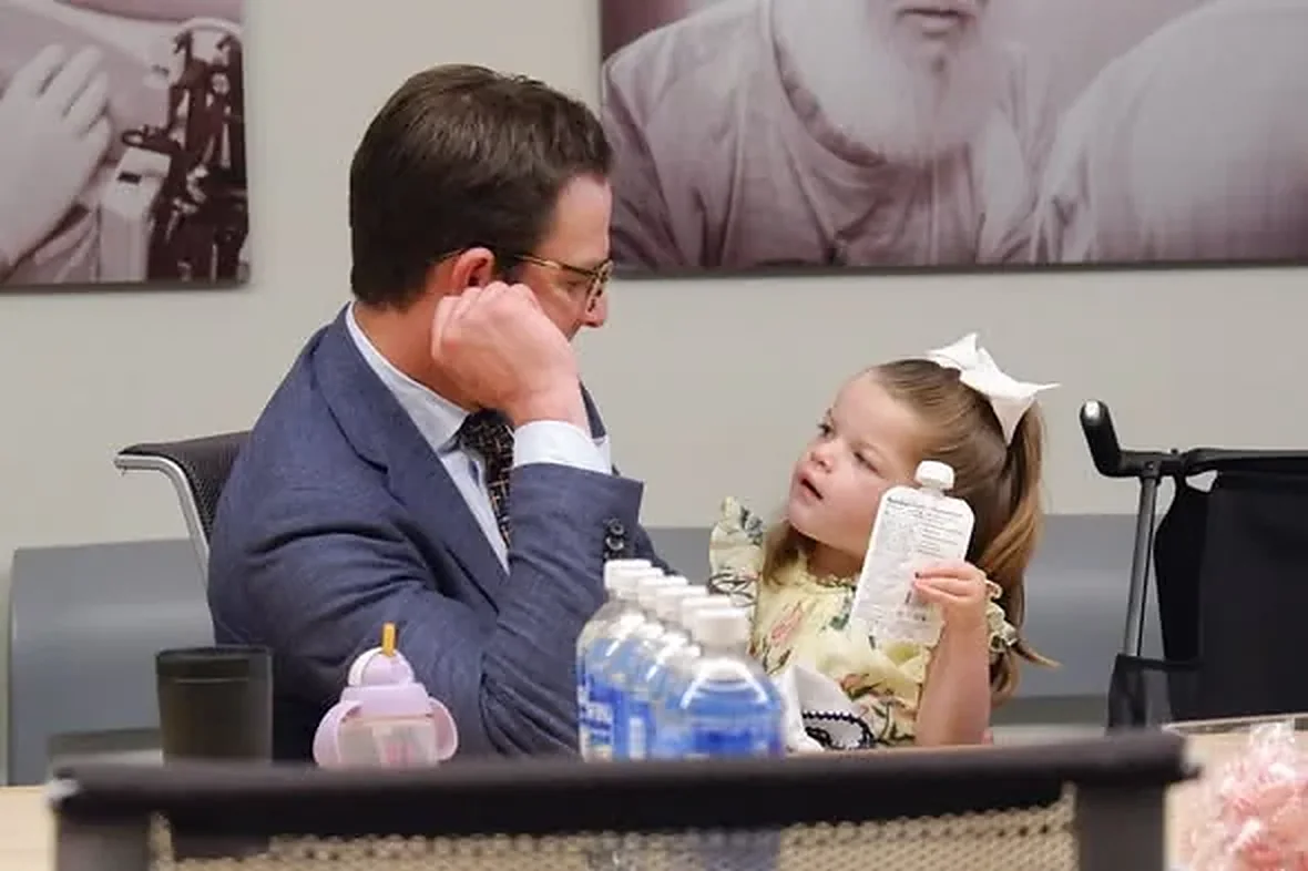 Isa with her father, Chris Lazzara, at the table on the morning the UF Health program opened
